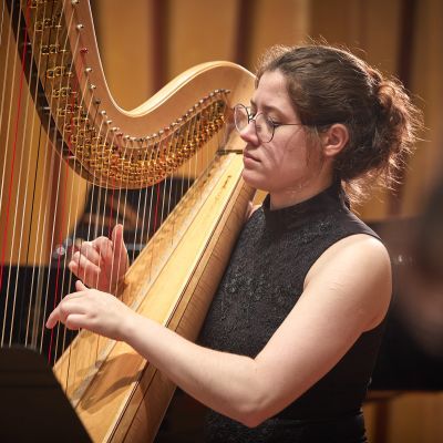 Student playing harp